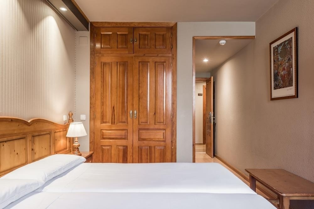 una habitación con una cama y un armario de madera