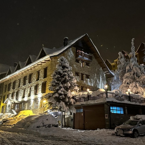 a car is parked in front of a snow covered building