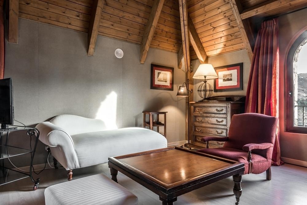 una sala de estar con un sofá blanco y una silla roja