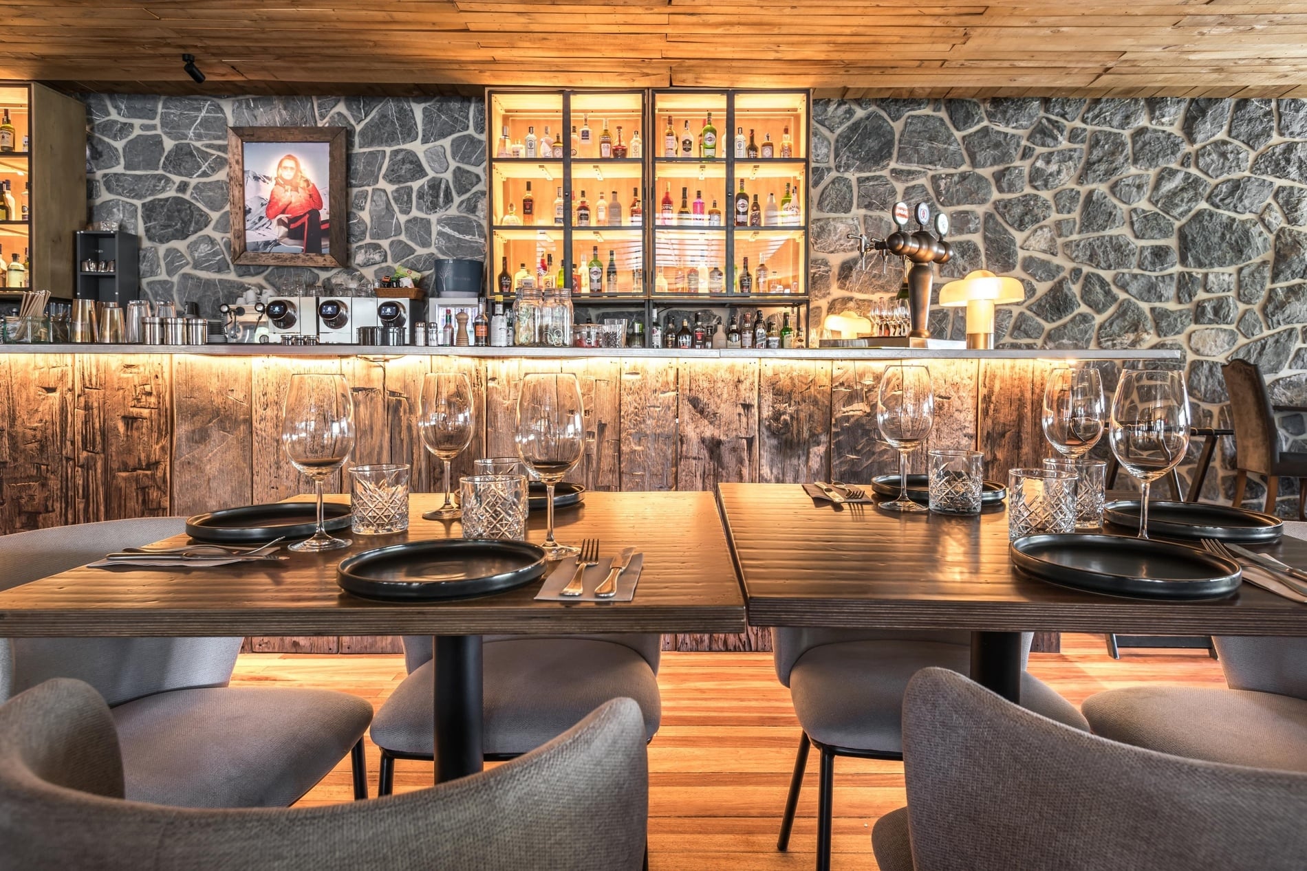 a table set with plates and glasses in front of a window