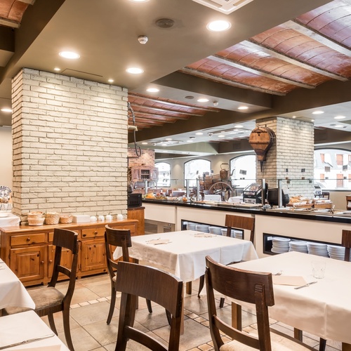 a restaurant with tables and chairs and a buffet
