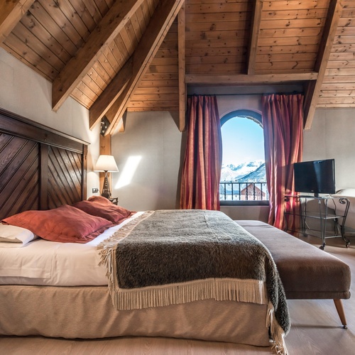 a hotel room with a large bed and a large window