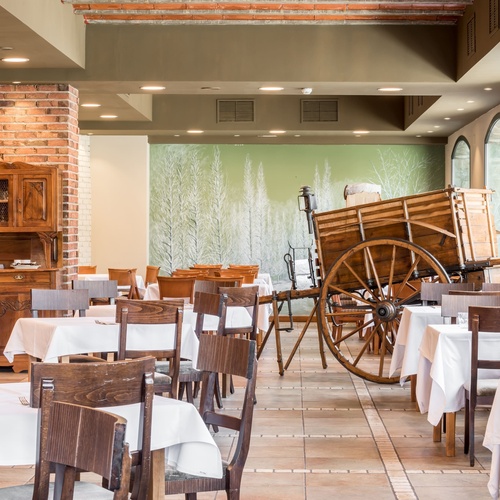 a restaurant with tables and chairs and a horse drawn carriage