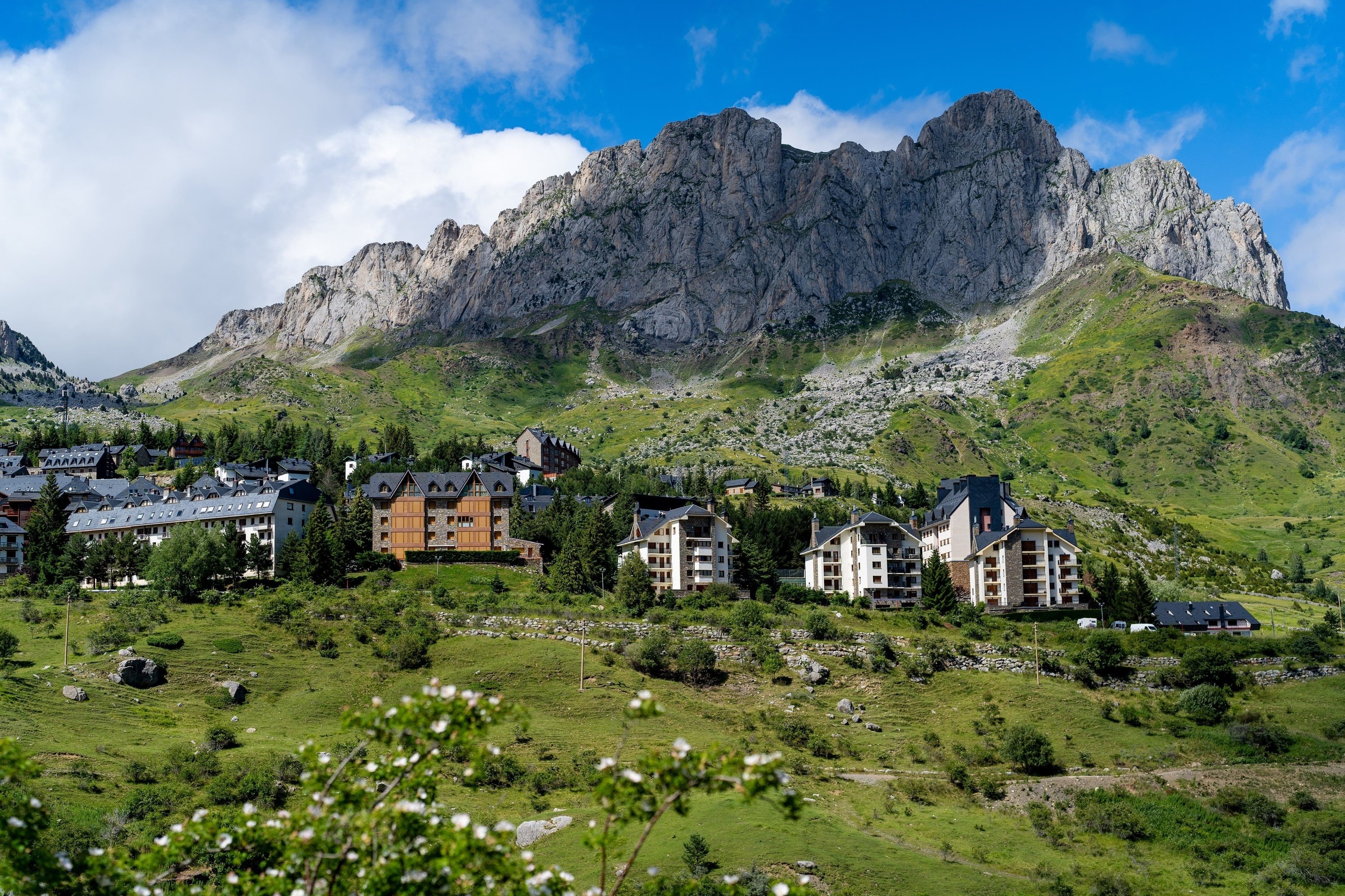 a mountain with a few buildings in the foreground