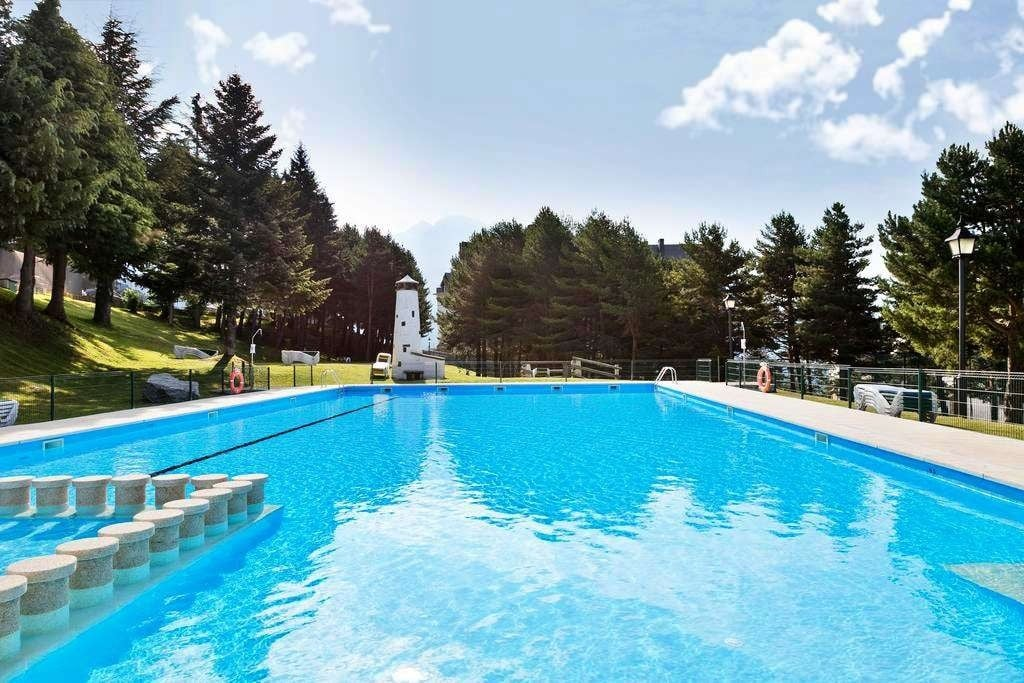 a large swimming pool with a lighthouse in the background