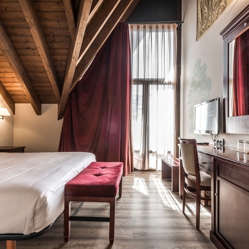 a hotel room with a large bed and a desk