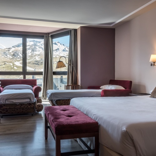 a hotel room with two beds and a couch