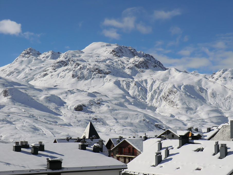 a mountain with a few buildings in the foreground