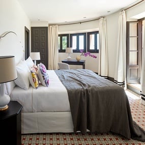 a bedroom with a large bed and two lamps
