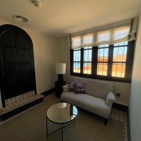 a living room with a couch and a table and a window