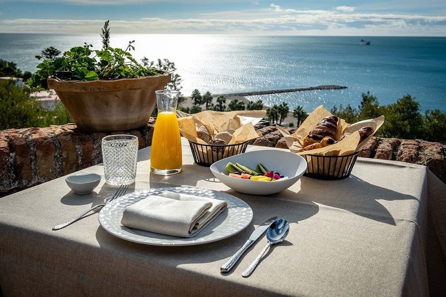 a table with a bowl of food and a pitcher of orange juice