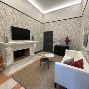 a living room with a fireplace and a flat screen tv