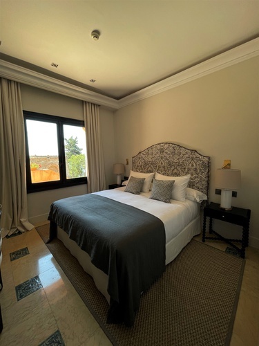 a bedroom with a large bed and a window