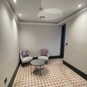 ein Wohnzimmer mit zwei Stühlen und einem Tisch
