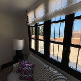 a living room with a striped couch and a lamp