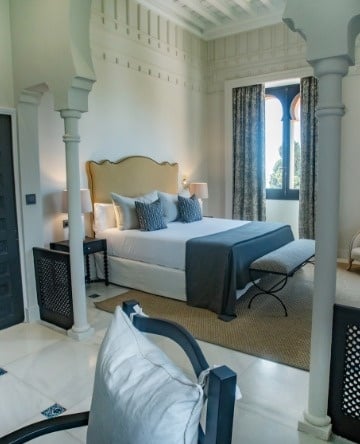 a bedroom with a king size bed and a chair