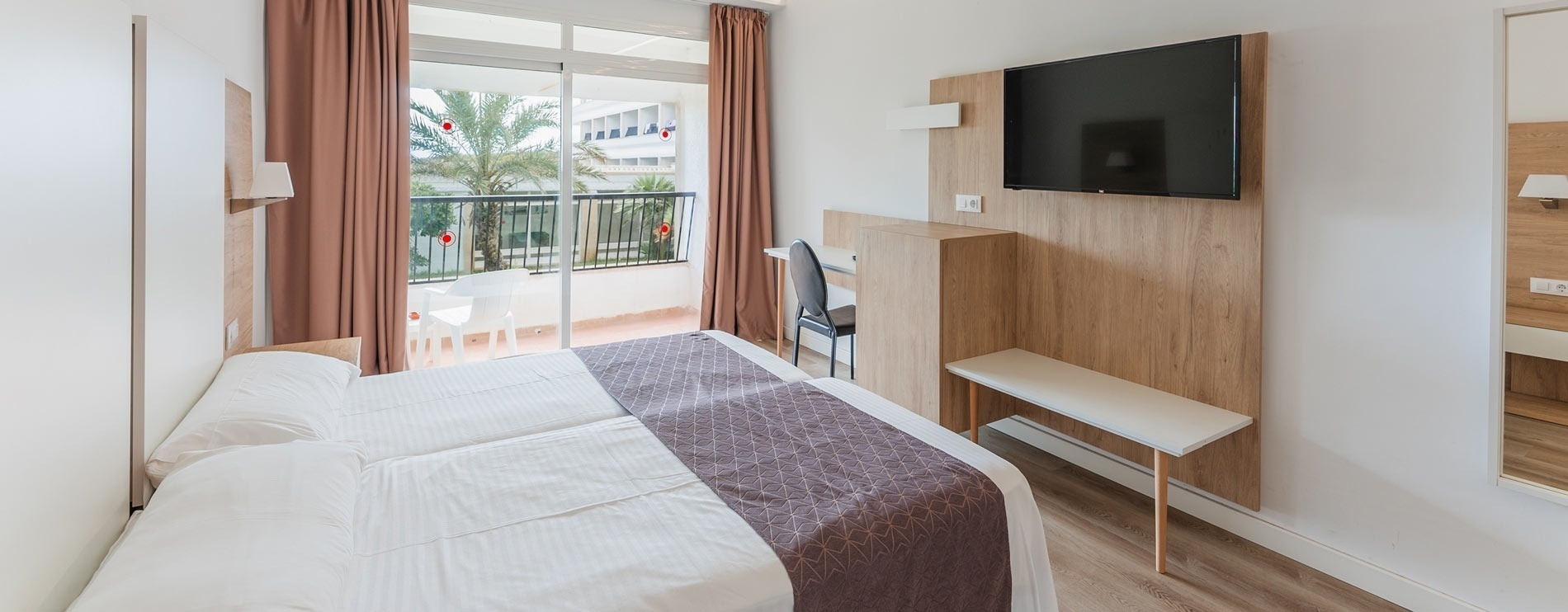 a hotel room with a large bed and a balcony