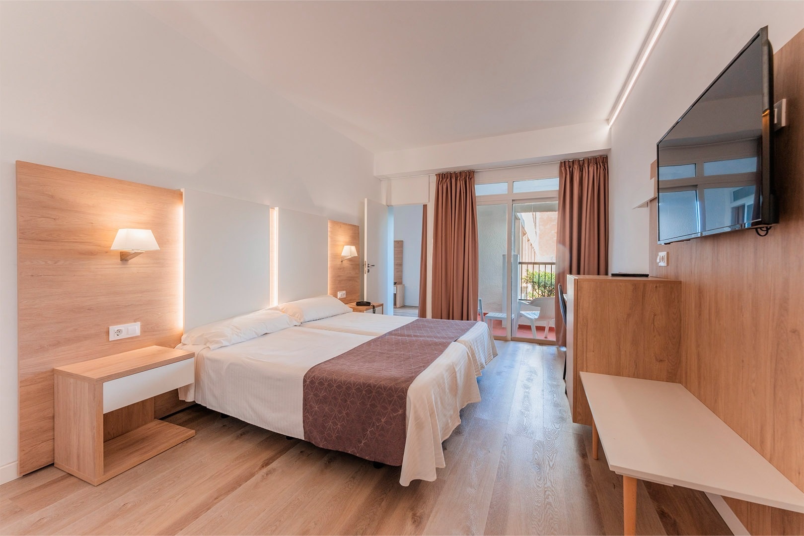 a hotel room with two beds and a desk