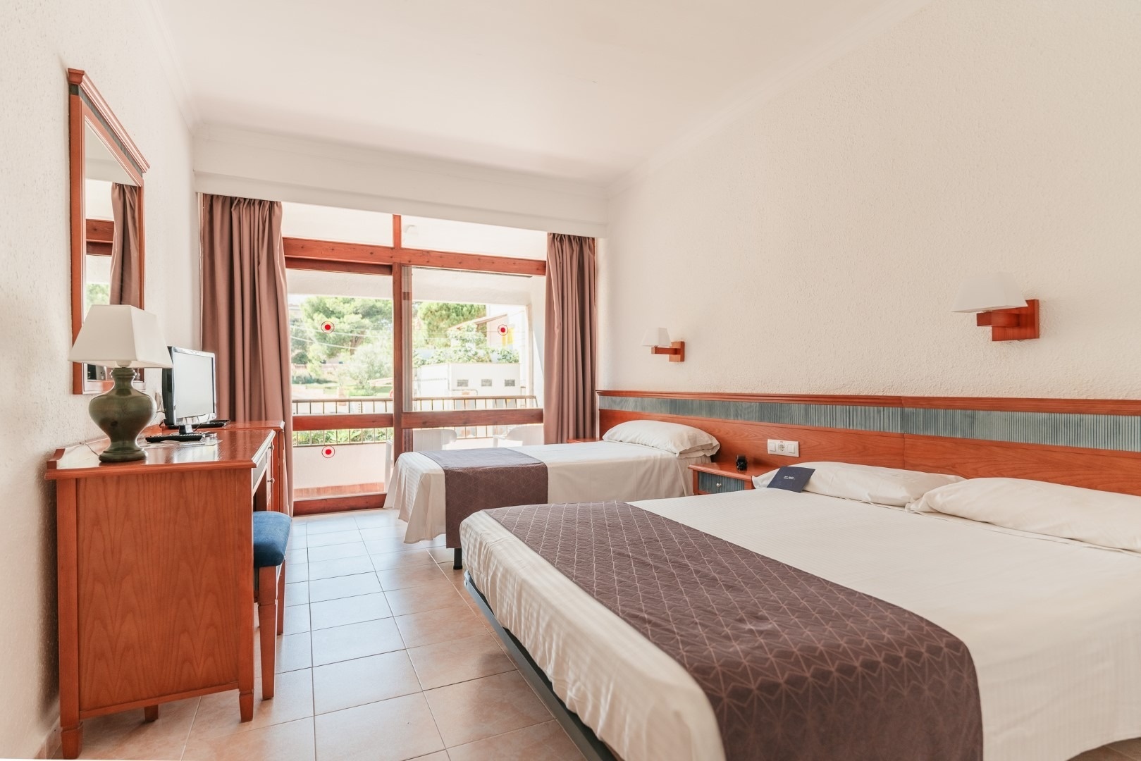 a hotel room with two beds and a desk