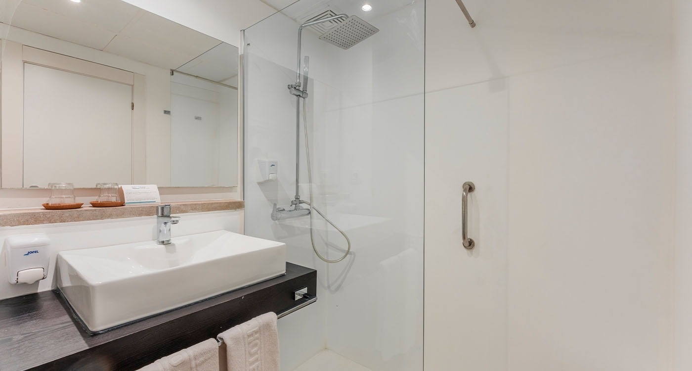 a bathroom with a sink a mirror and a shower