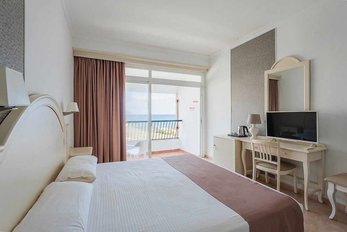 a hotel room with a large bed and a flat screen tv