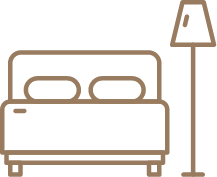 un icono de una cama y una lámpara sobre un fondo blanco .