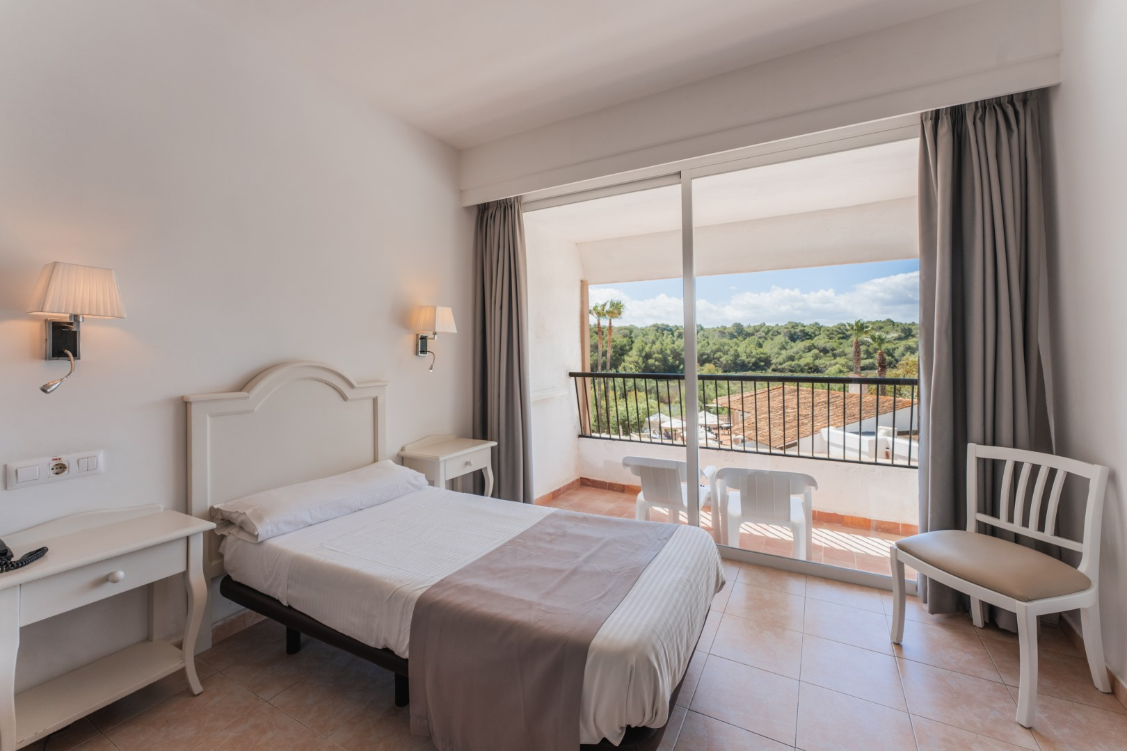 a hotel room with a large bed and a flat screen tv