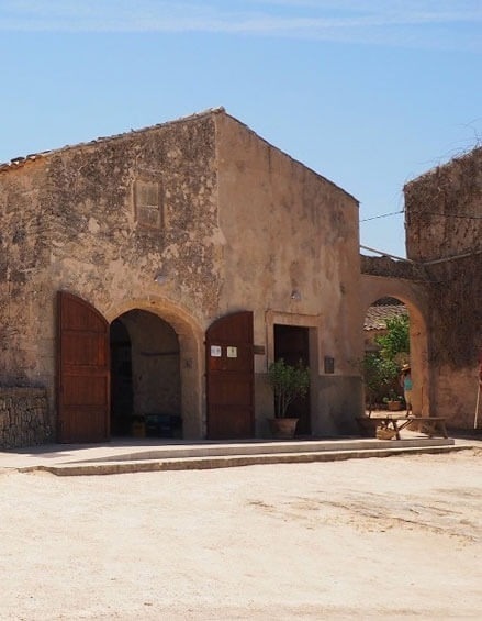 un edificio marrón con puertas de madera abiertas