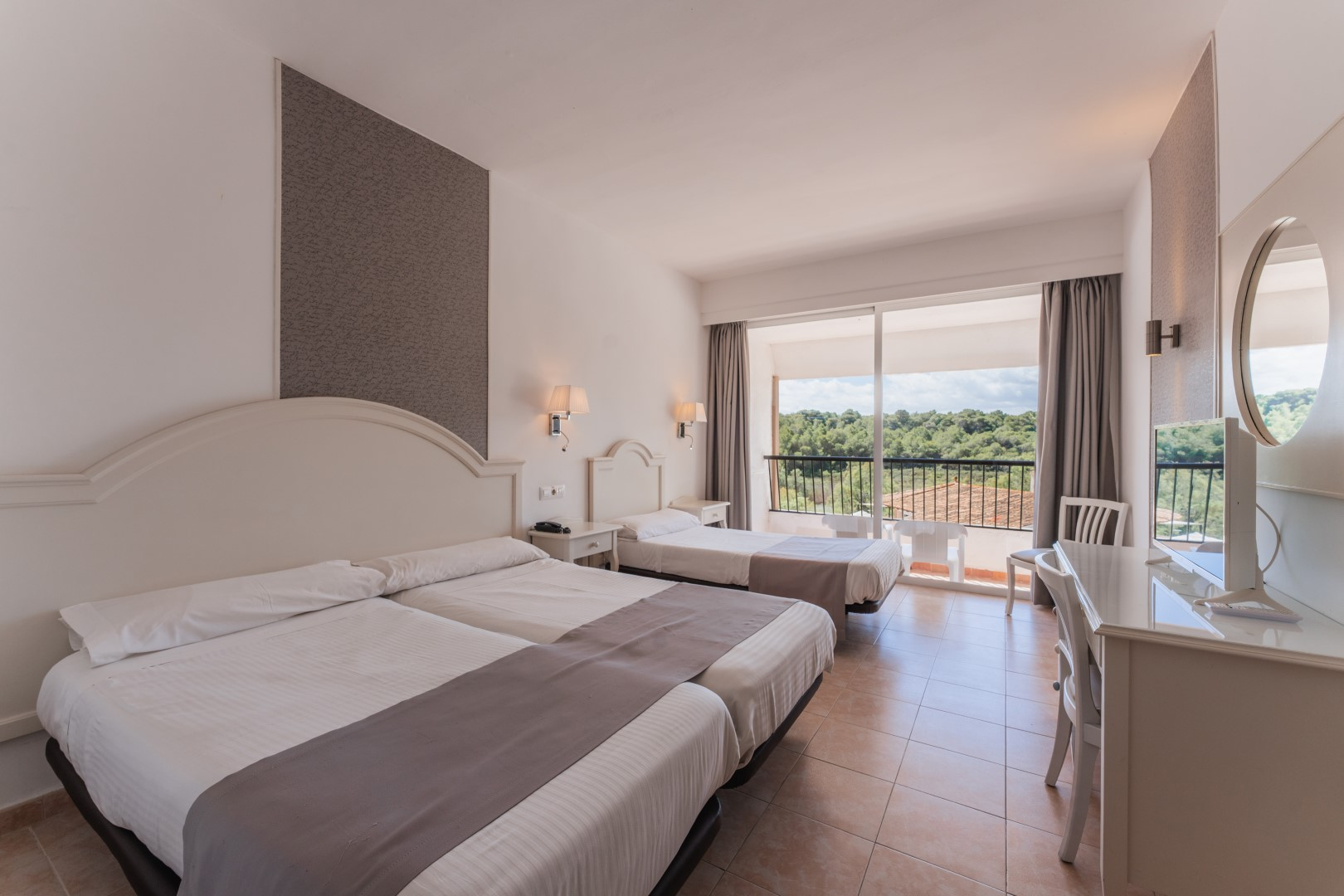 a hotel room with two beds and a desk