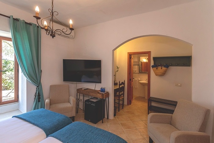 een slaapkamer met twee bedden en een flatscreen-tv