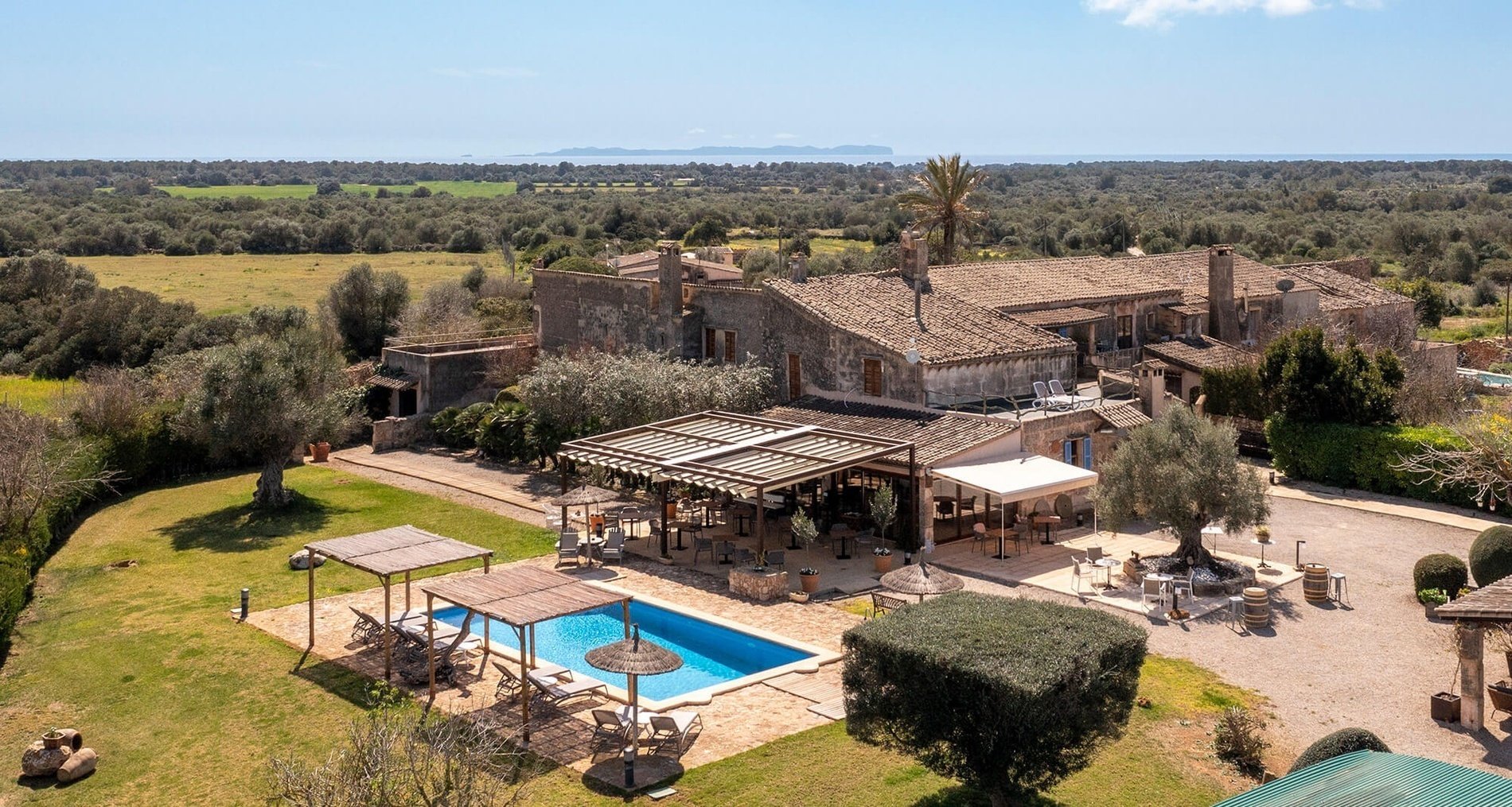a large house with a large swimming pool in front of it