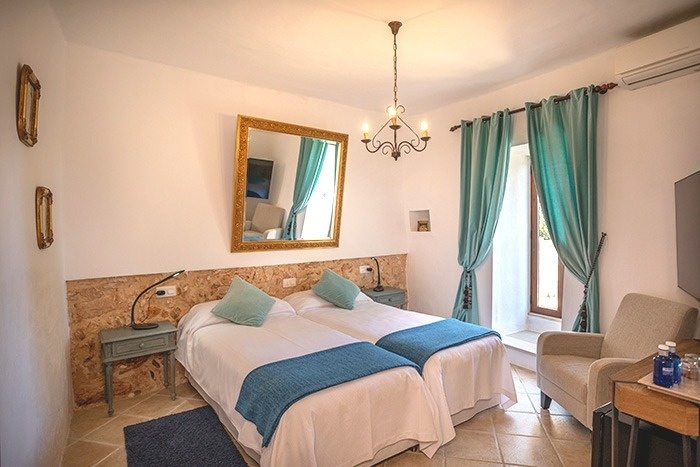 una habitación con dos camas , una silla y un espejo