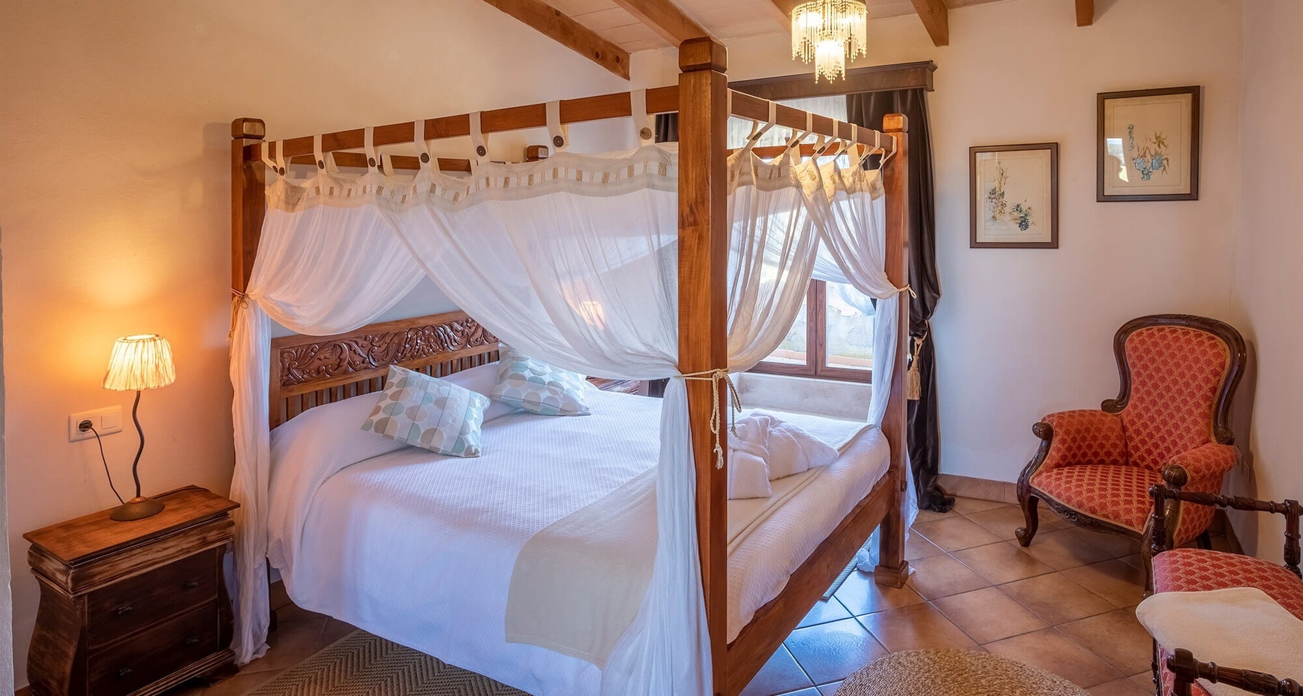 a bedroom with a canopy bed and a chair