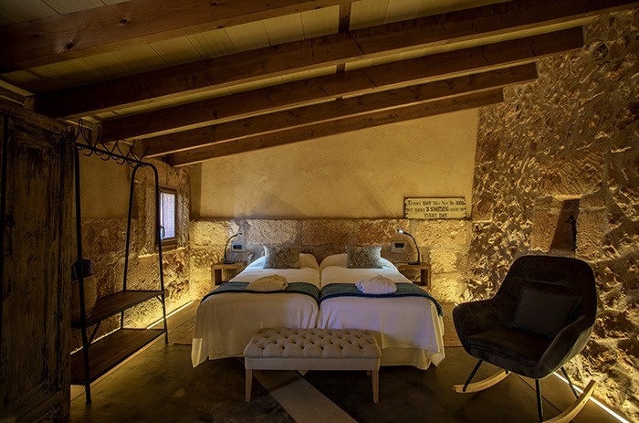 een slaapkamer met twee bedden en een schommelstoel