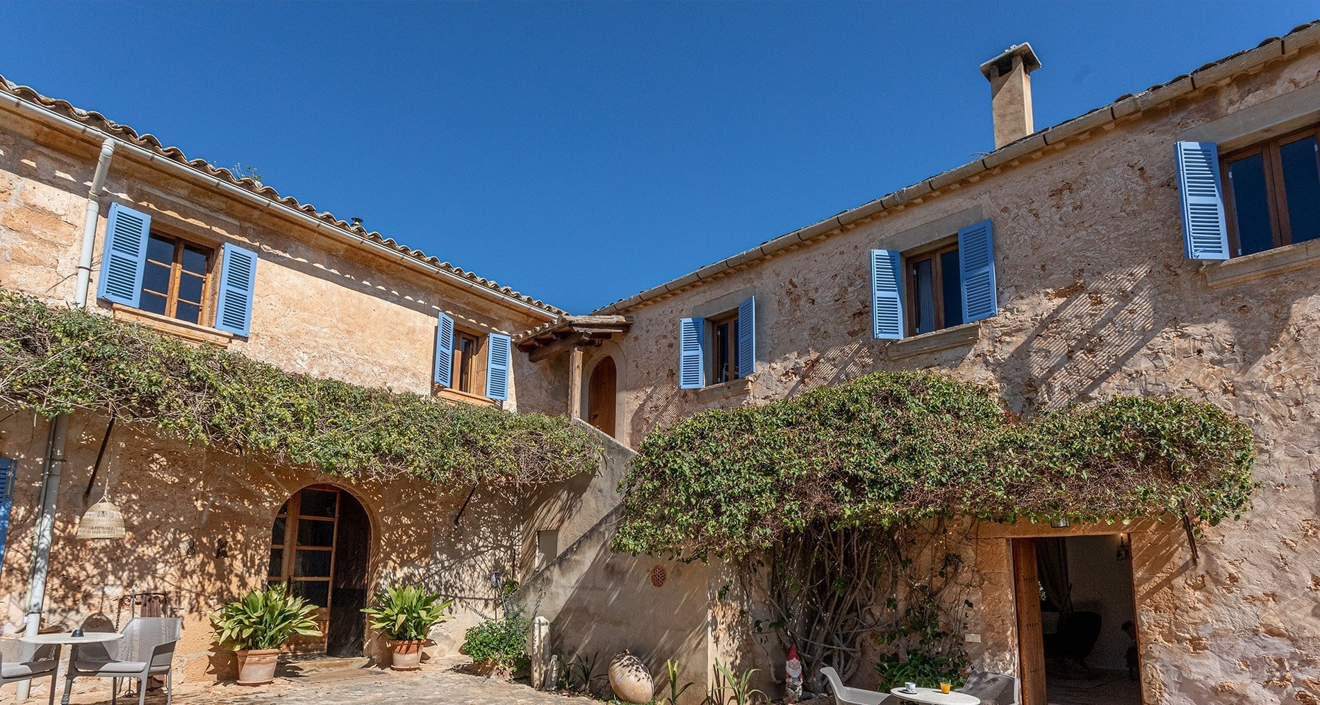 a stone building with blue shutters on the windows