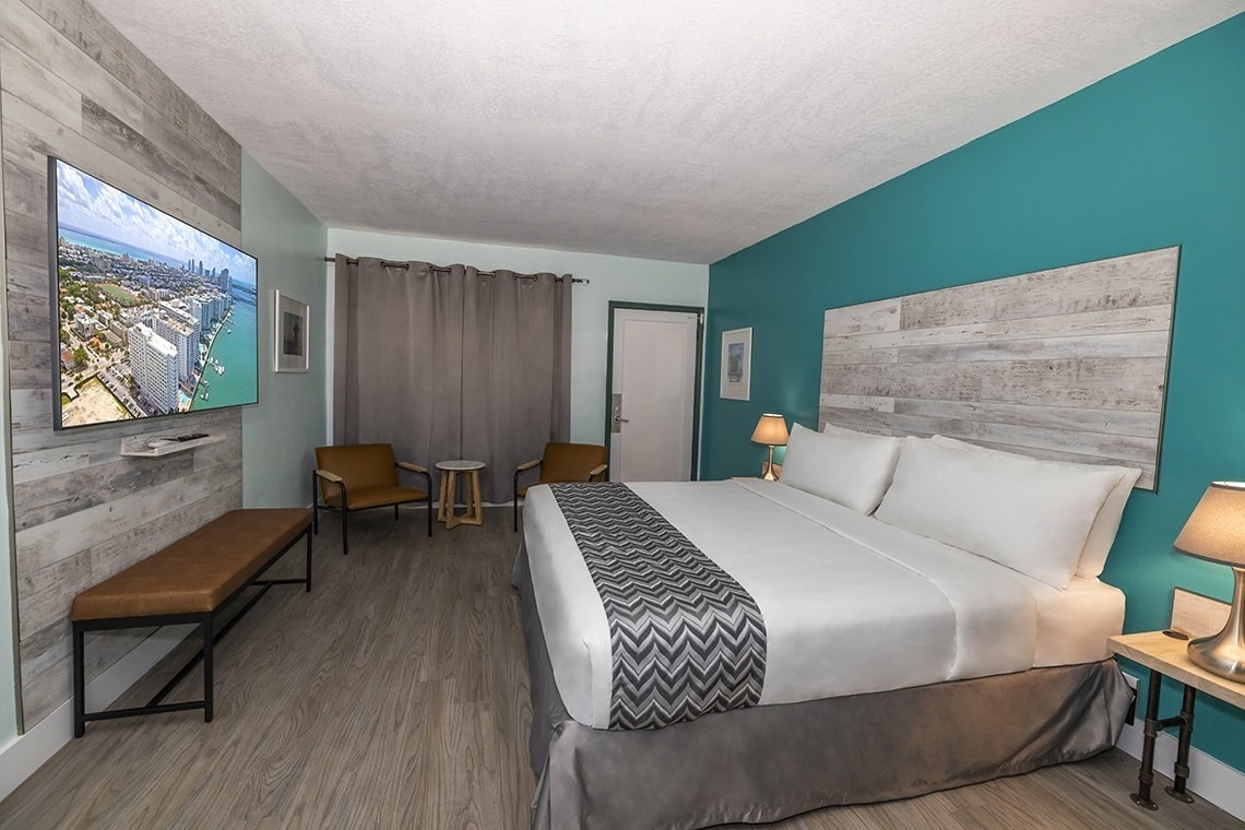 a hotel room with a king size bed and a flat screen tv