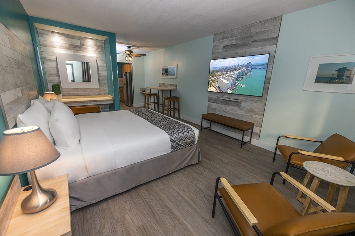 a hotel room with a king size bed and a flat screen tv