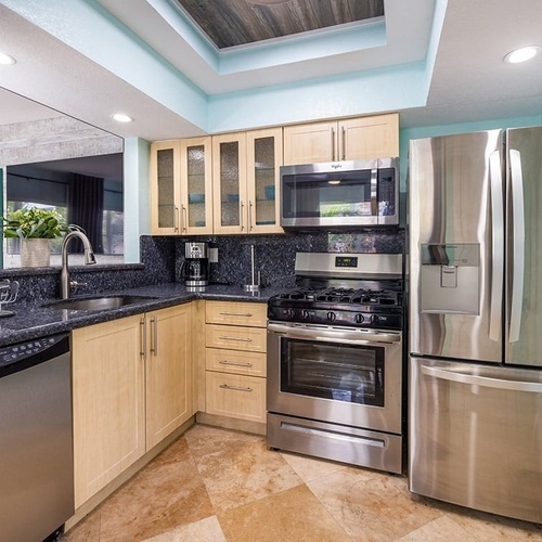 a kitchen with stainless steel appliances including an lg refrigerator