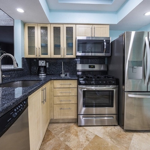 a kitchen with stainless steel appliances including a frigidaire refrigerator