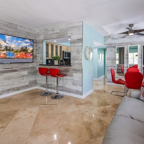 a living room with a flat screen tv on the wall