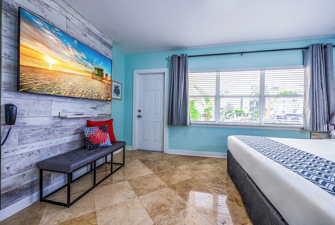 a hotel room with a large flat screen tv on the wall