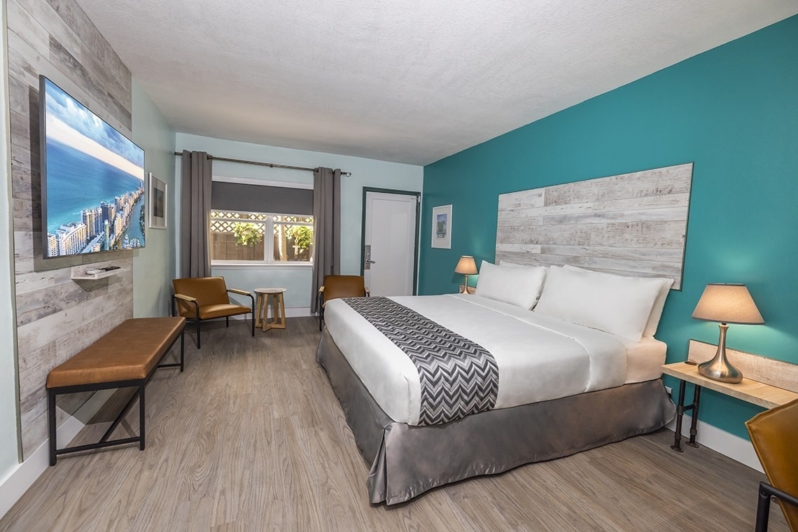 a hotel room with a king size bed and a flat screen tv