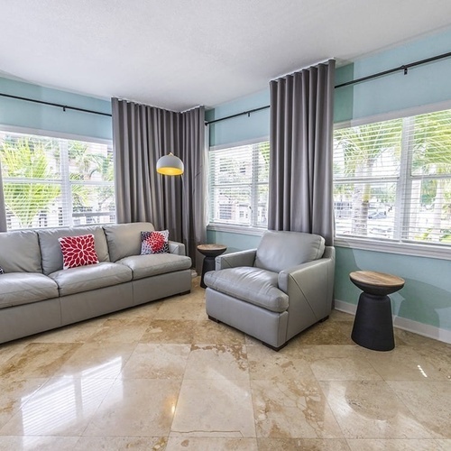 a living room with a couch and two chairs