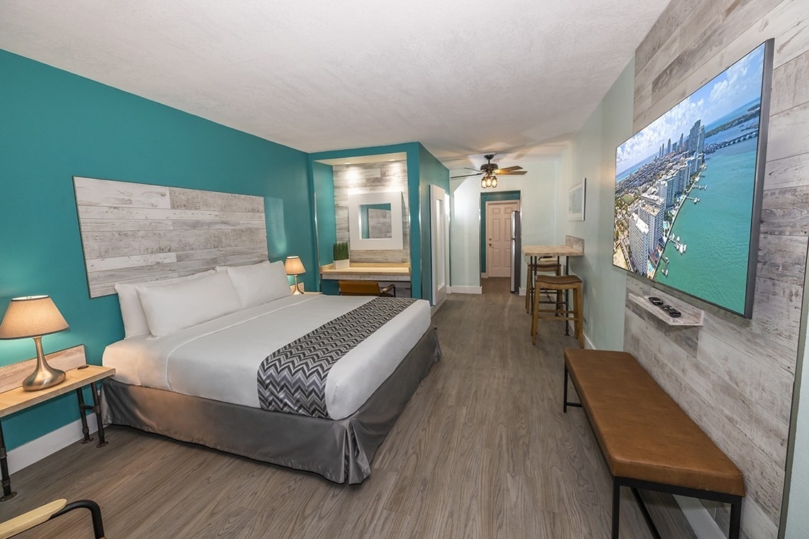 a hotel room with a king size bed and a flat screen tv