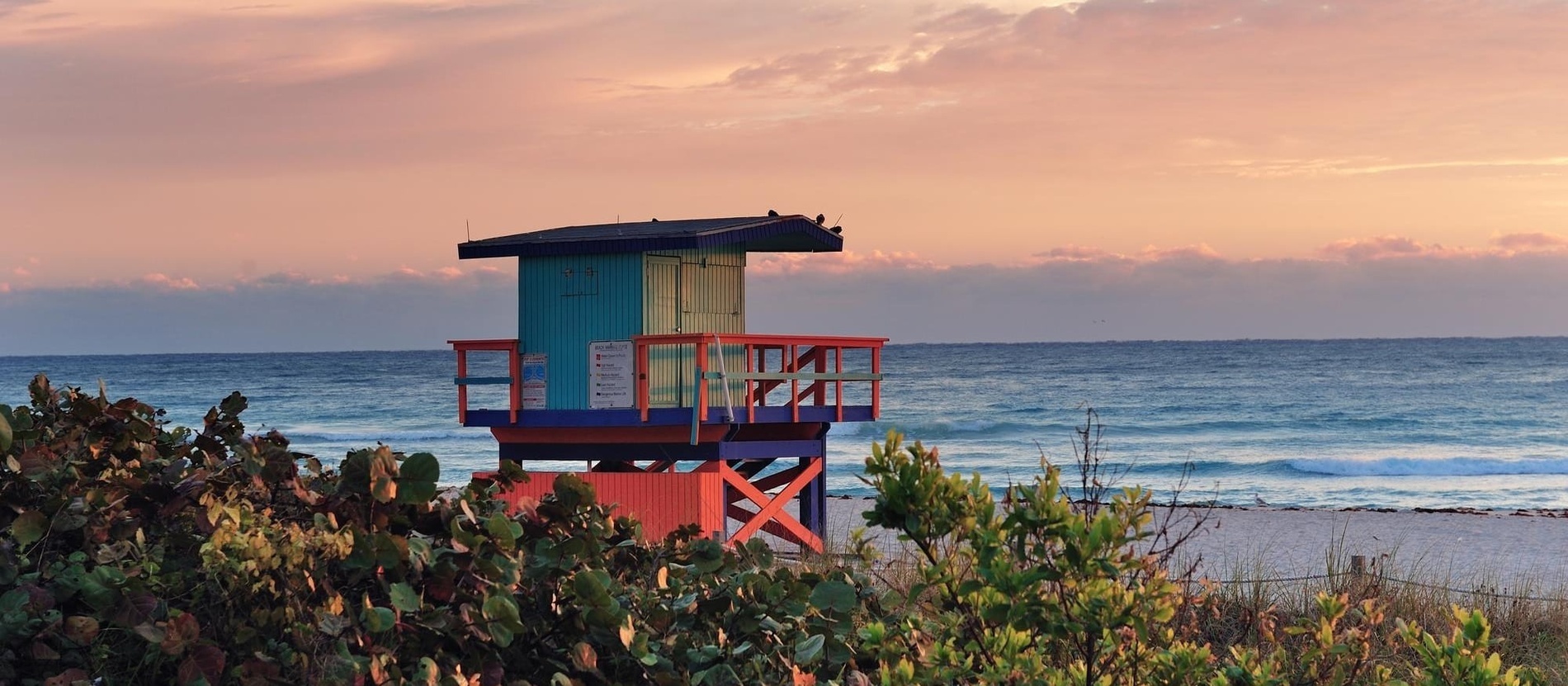 a beach with a lifeguard tower in the foreground