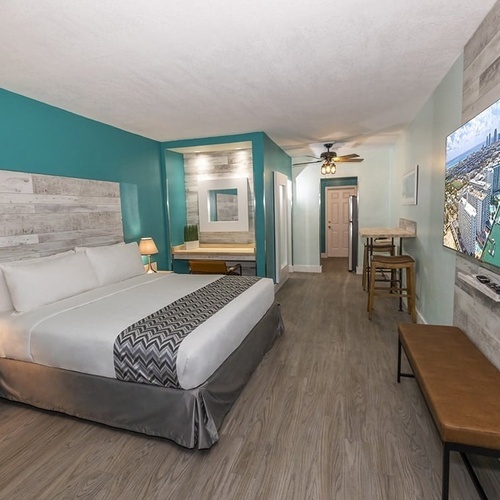 a hotel room with a king size bed and a flat screen tv