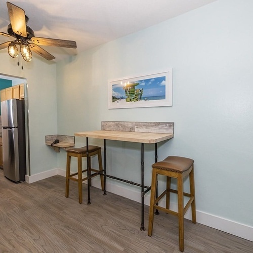 a picture of a lifeguard tower hangs above a small table