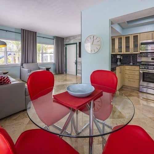 a kitchen and dining area with a clock on the wall