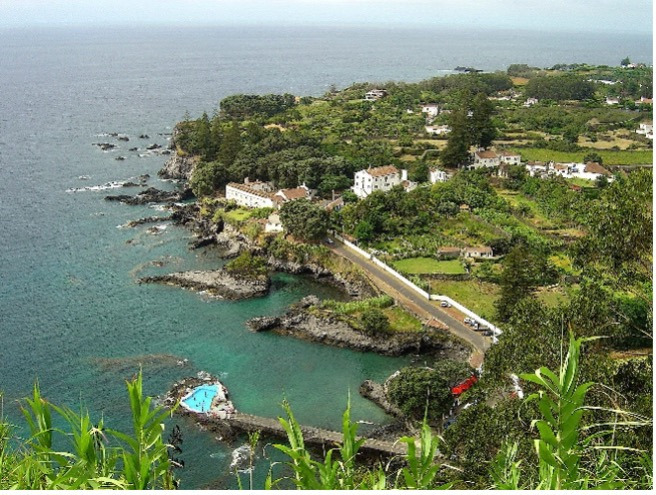 Ponta Delgada Airport at night, a modern Sul Villas & Spa with lit runway and parking.