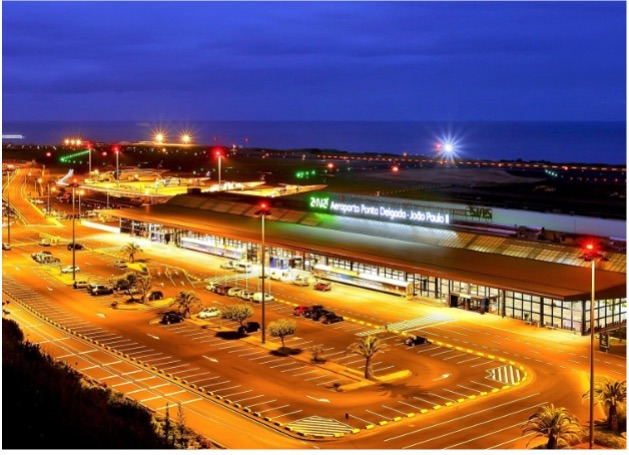 Ponta Delgada Airport at night, a modern Sul Villas & Spa with lit runway and parking.